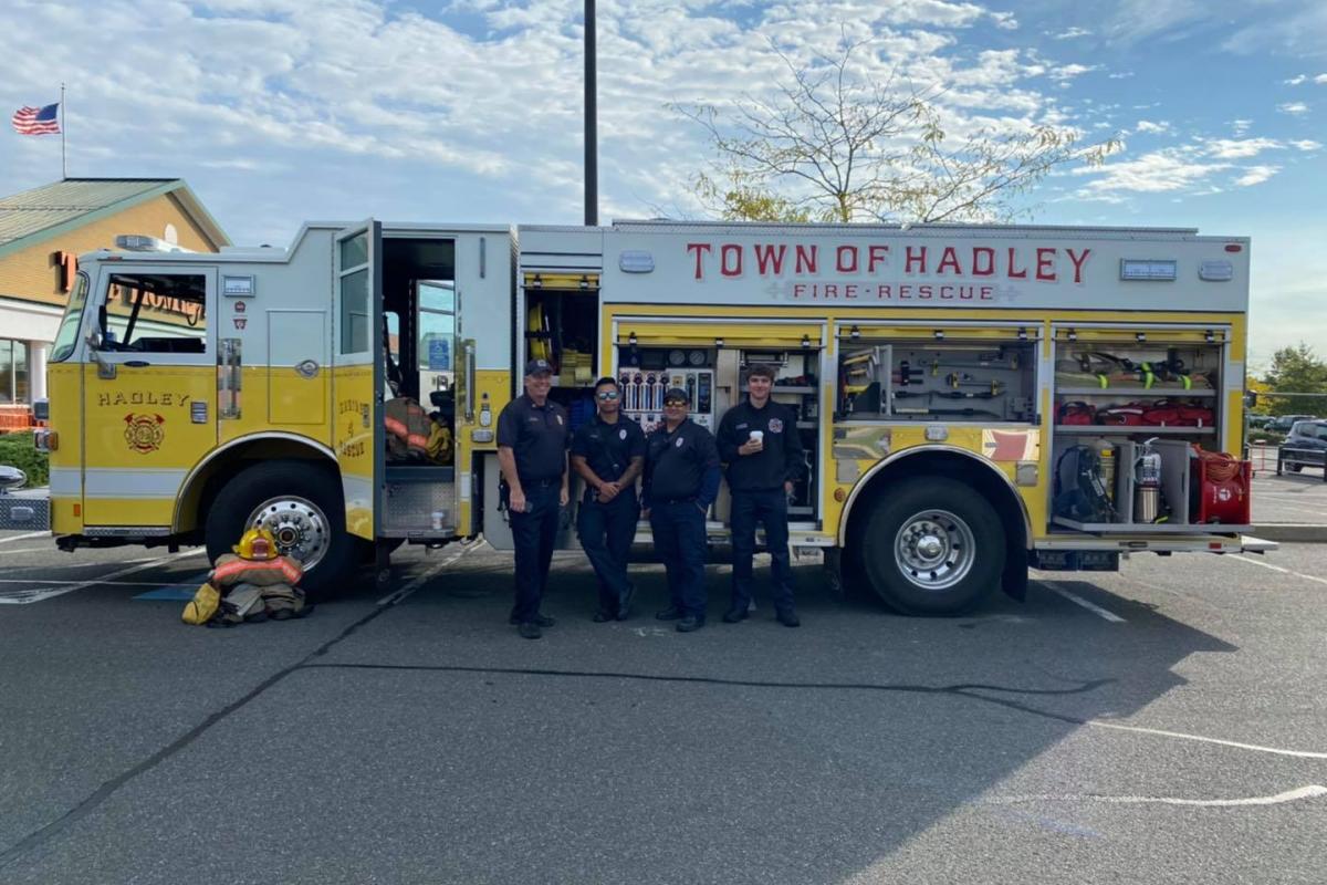 Hadley yellow fire truck with crew kneeling and posing in front