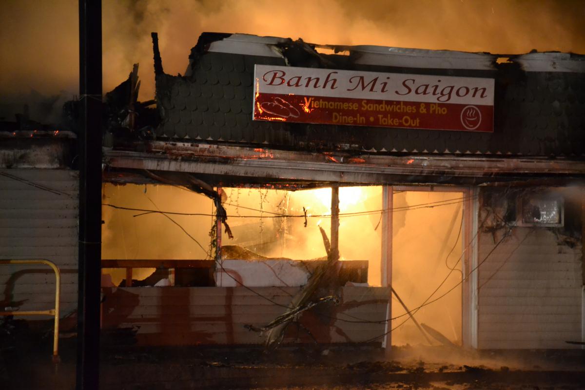 Storefront with fire inside and smoke behind.