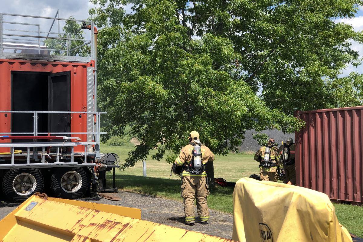 Fire fighter with most of his gear on watching the training trailer.