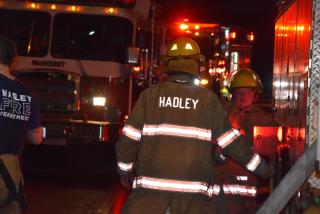 Hadley firefighters near fire trucks.